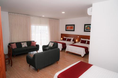 a hotel room with two beds and a couch at Rio Cumbaza Hotel in Tarapoto