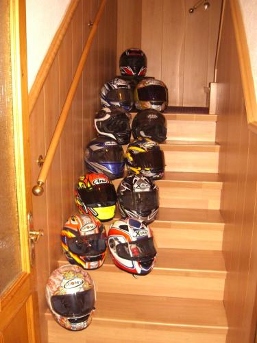 a bunch of helmets are lined up on stairs at Albergo Alpino in Vermiglio