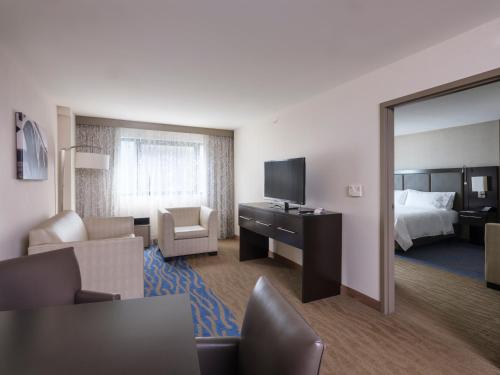 a hotel room with a bed and a desk with a television at Holiday Inn Washington Capitol-National Mall by IHG in Washington