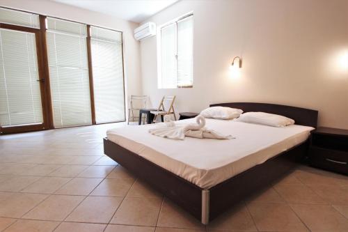 a bedroom with a bed with a towel on it at Menada Midia Apartments in Sunny Beach