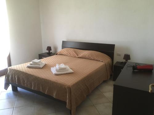 Ένα ή περισσότερα κρεβάτια σε δωμάτιο στο Residence S’Oggiastrone