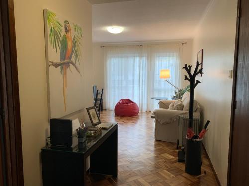 a living room with a couch and a table at Garden Apartment, great for couple - Ponta Delgada in Ponta Delgada