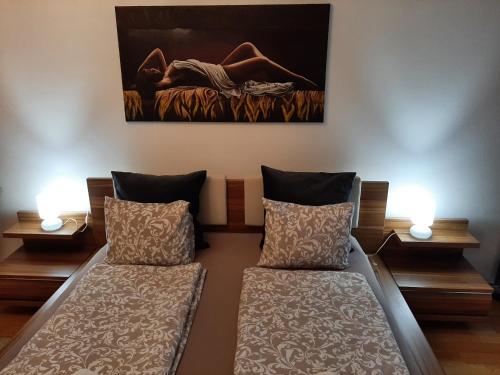 a room with two beds and a painting on the wall at Nobless Apartment Brno in Brno