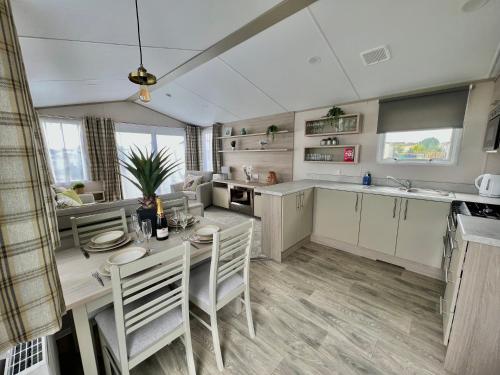 a kitchen with a table and chairs in a room at Summer Breeze @ Seven Bays, Padstow in Padstow