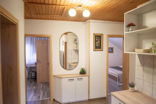 a small room with a mirror and a bedroom at Rooms Ruza in Smoljanac