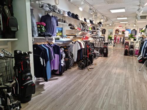a store aisle with a lot of clothes on display at Hotell Stavstensgården in Trelleborg