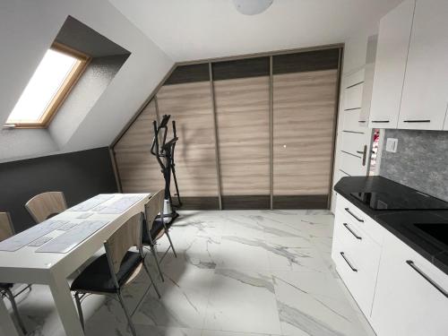 a kitchen with a table and chairs in a room at Mieszkanie Giżycko in Giżycko