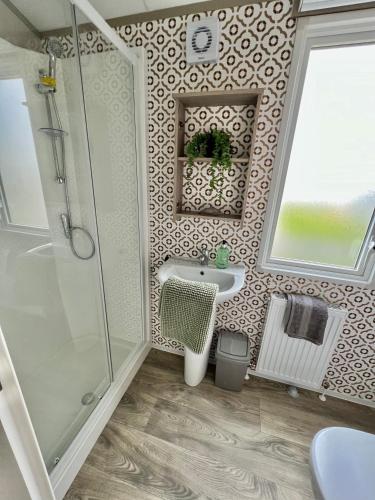a bathroom with a shower and a sink at Summer Breeze @ Seven Bays, Padstow in Padstow