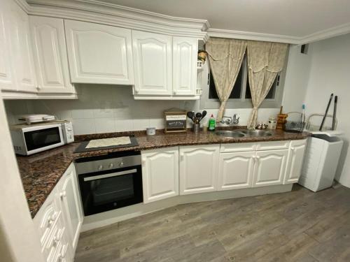 a kitchen with white cabinets and a counter top at Piley apartamento en vila-real in Villareal