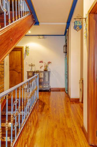 a hallway with a staircase in a house at Hotel Azul de la Plaza by Chat Noir in Cuenca