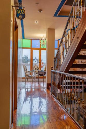 a hallway with a staircase and a colorful ceiling at Hotel Azul de la Plaza by Chat Noir in Cuenca