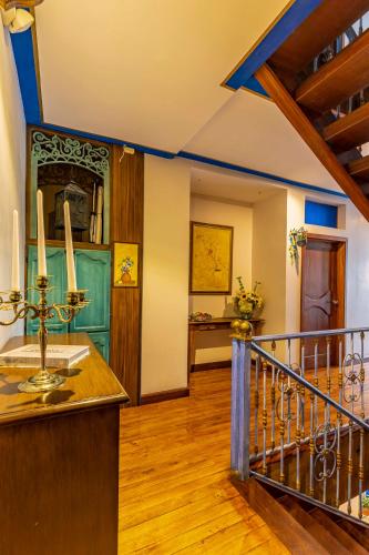 a room with a staircase with a blue ceiling at Hotel Azul de la Plaza by Chat Noir in Cuenca