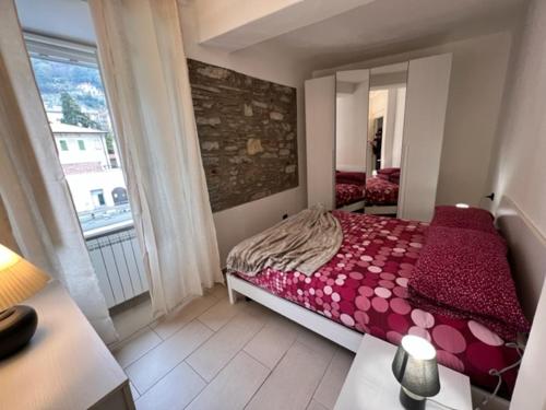 a bedroom with a bed and a large window at Risveglio in Como