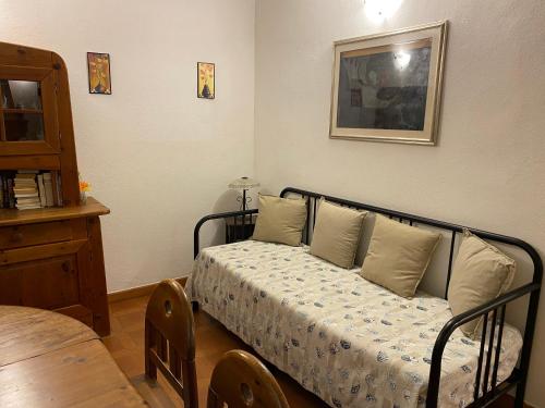 a bedroom with a bed with pillows and a table at Villa Paradisino in Orbetello
