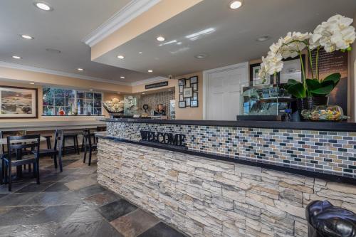 a bar in a restaurant with chairs and tables at Stage Coach Lodge in Monterey