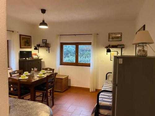a kitchen and dining room with a table and chairs at Villa Paradisino in Orbetello