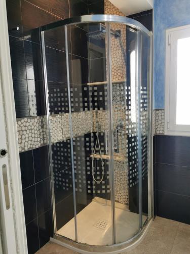 a shower with a glass door in a bathroom at Beach front Esther 4 villajoyosa in Villajoyosa