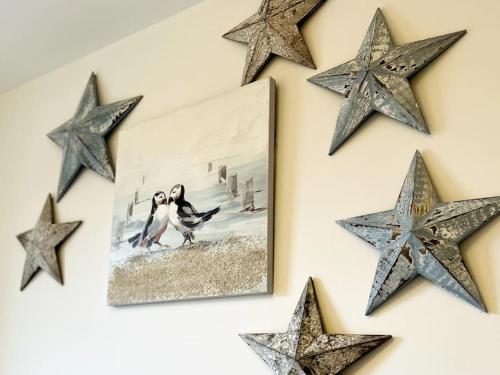 a wall with stars and a picture on it at Riverside View Apartment in Balloch, Loch Lomond in Balloch