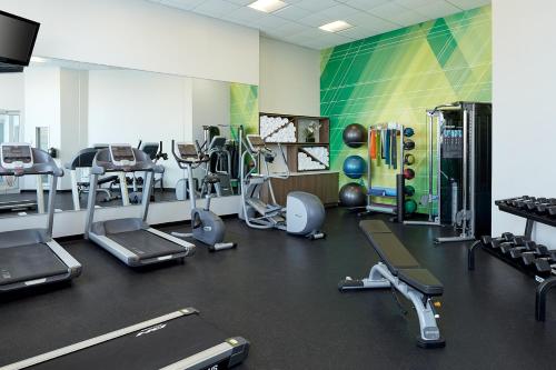 a gym with several treadmills and cardio machines at Holiday Inn & Suites Montreal Airport by IHG in Dorval