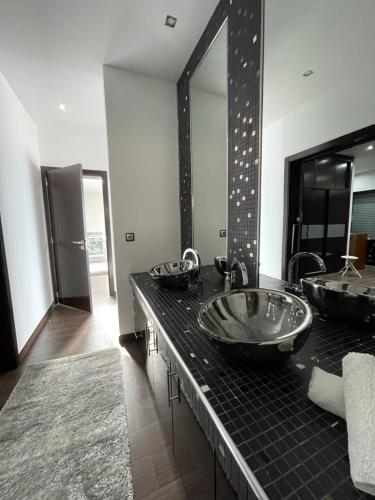 a bathroom with two sinks and a large mirror at Vivenda Luxuosa in Feteiras