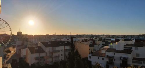 a view of a city with a ferris wheel at Coquet studio au centre port du Cap d'Agde in Cap d'Agde