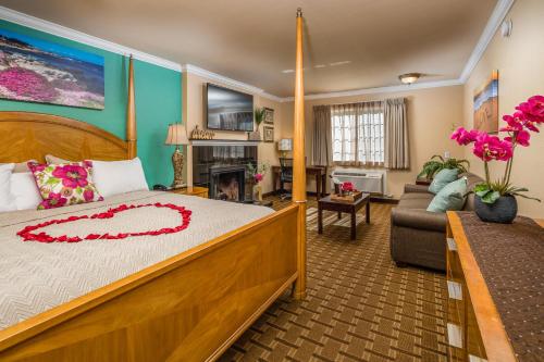 a bedroom with a large bed and a living room at Stage Coach Lodge in Monterey