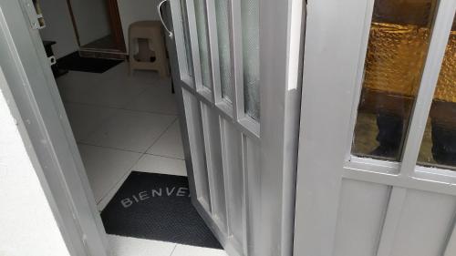 an open door with a welcome mat in a room at Apartamento-Habitación Palonegro Manizales in Manizales