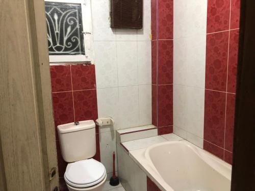 a bathroom with a toilet and a bath tub at Apartment near Abdeen Palace & Museum in Cairo