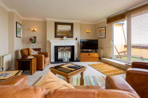 a living room with a couch and a fireplace at The Beachcroft Hotel, BW Signature Collection in Bognor Regis