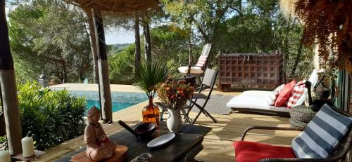 a patio with a table and chairs and a pool at Ying Yang Monte da Lua in Comporta