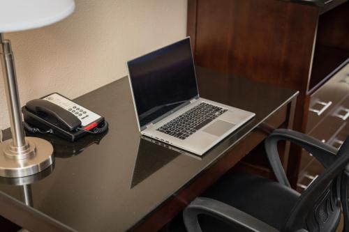 a laptop computer sitting on top of a wooden desk at Stage Coach Lodge in Monterey