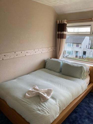 a bed in a room with a window at 'Melrose' at stayBOOM in Lancaster