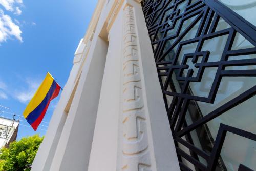 a flag is flying next to a building at Hotel Republicano 1910 in Girardot