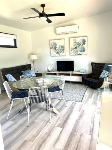 a living room with a table and chairs at Farm Stay POPLAR Cottage at Wilindi Estate in Tyabb
