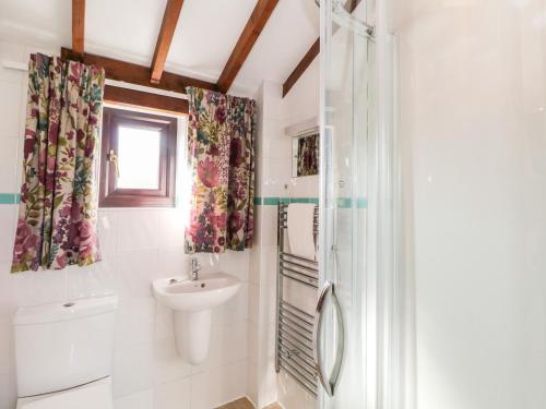 a bathroom with a sink and a shower at Heath Cottage in Edale