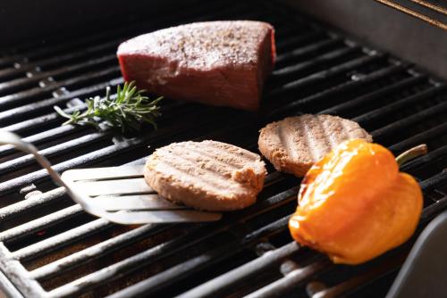 a steak and bread on a grill with a fork at VILLA HAKONE湖空 in Hakone