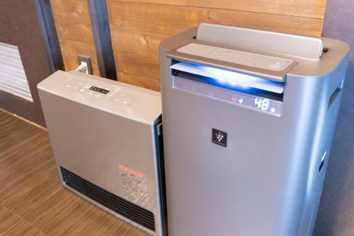 a small refrigerator next to a wall with a fax at VILLA HAKONE湖空 in Hakone