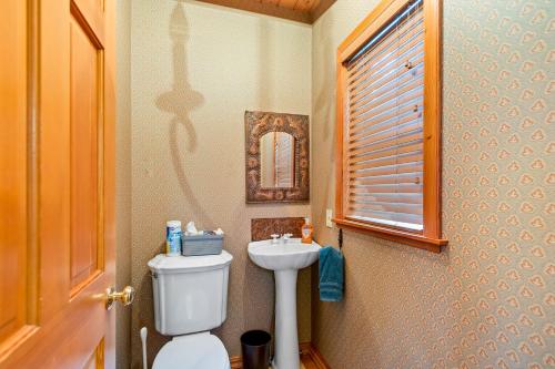 a small bathroom with a toilet and a sink at Blue Raven Mountain Home in Sagle