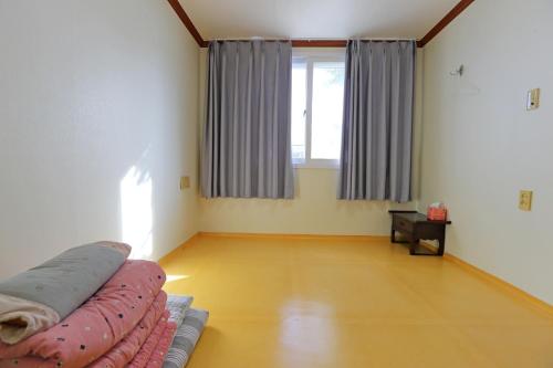 a living room with a couch and a window at Pension Seoak in Gyeongju