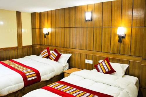 A bed or beds in a room at Hotel Grand Shambala