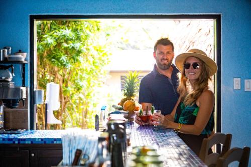a man and a woman standing at a table at Mariposa Belize Beach Resort in Placencia Village