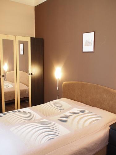 a bedroom with a bed and a mirror at Budapest Suites in Budapest