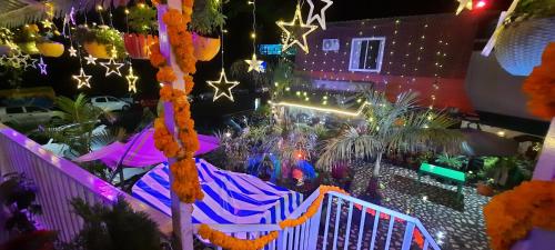 a view of a patio at night with christmas lights at HOTEL POLOMAX in Nainital