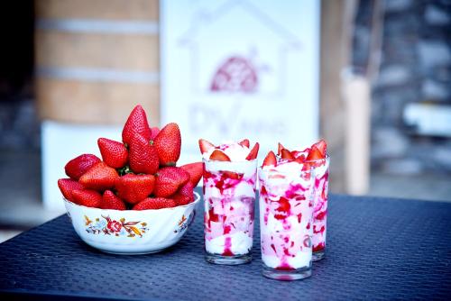 three glasses of strawberries and a bowl of strawberries at DV INNS FARMVILLA - Besides Strawberry Farms in Mahabaleshwar