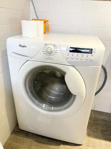 a white washing machine in a bathroom at Greatwood Residence at Devonshire in Singapore