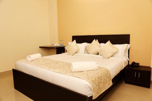 a bedroom with a large bed with white sheets and pillows at The Park Classic Udaipur in Udaipur