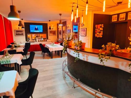 a restaurant with tables and chairs and a bar at Great Polonia Beach & Molo in Puck