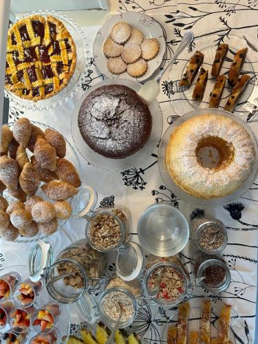 a table topped with different types of pastries and pies at Hotel Clodia - Adults Only in Sirmione