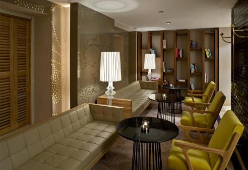 a living room filled with furniture and a large window at Witt Istanbul Suites in Istanbul