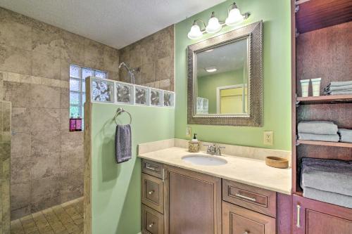 a bathroom with a sink and a mirror and a shower at Vero Beach Oasis Less Than 7 Mi to South Beach Park! in Vero Beach
